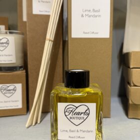 Our Lime, Basil and Mandarin Pomegranate reed diffuser displayed on a shelf.