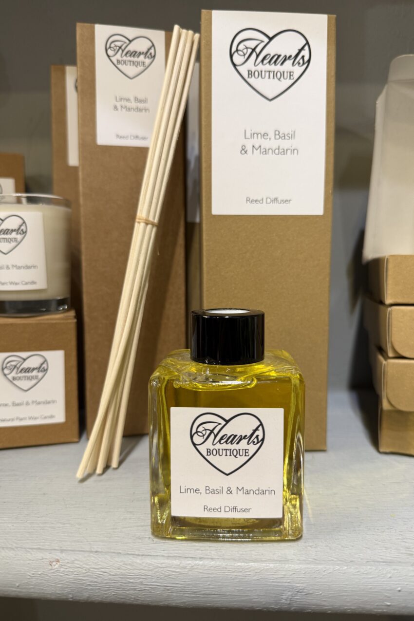 Our Lime, Basil and Mandarin Pomegranate reed diffuser displayed on a shelf.