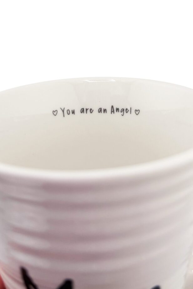 White ceramic mug up close to show detail inside that reads "You are an Angel"