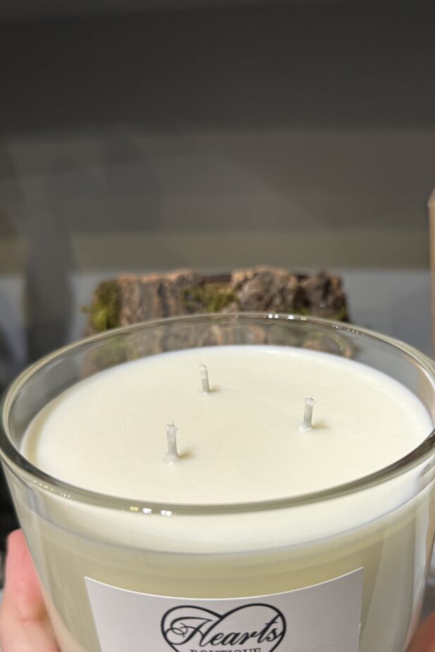 Three wick candle upclose image.